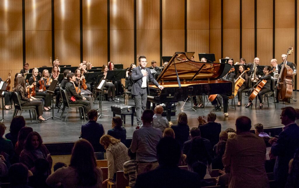 Yibing Zhang takes bow from piano with Dallas Chamber Symphony