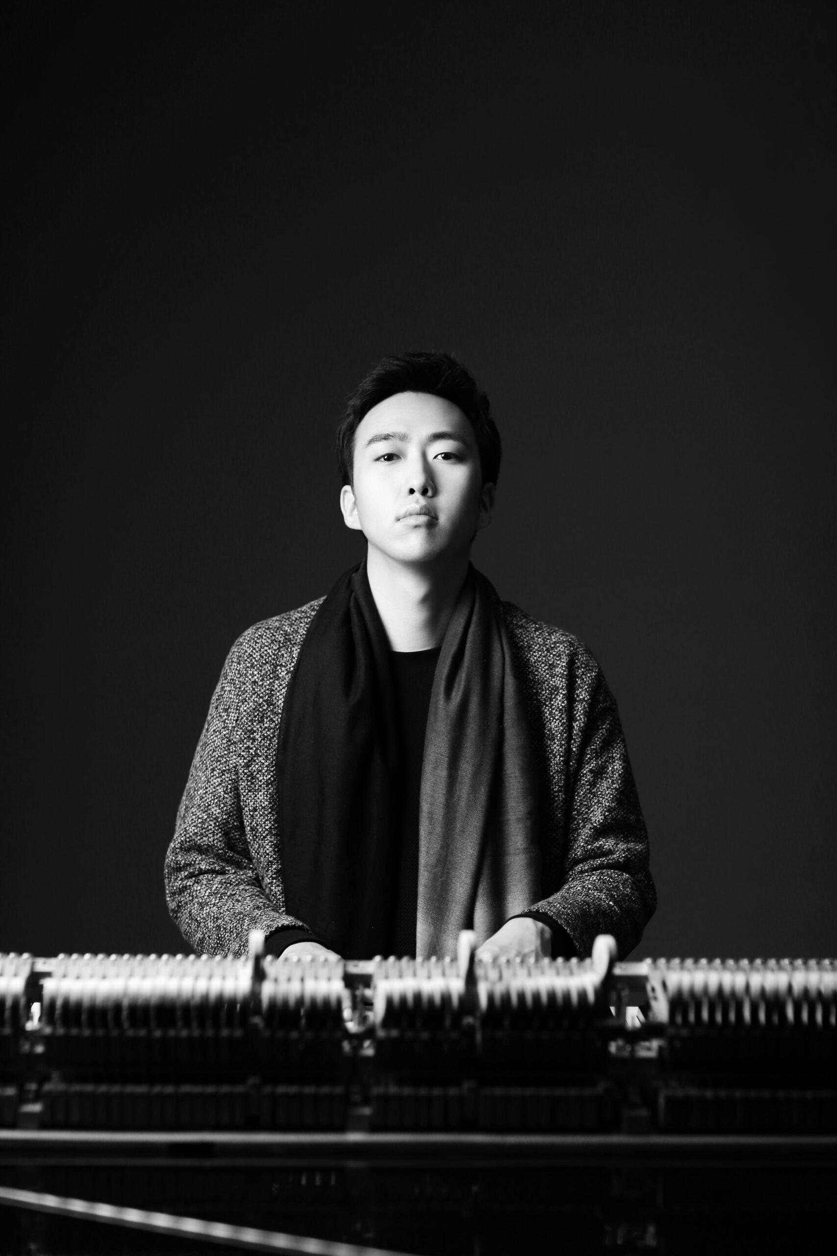 Jiwon Han standing at piano